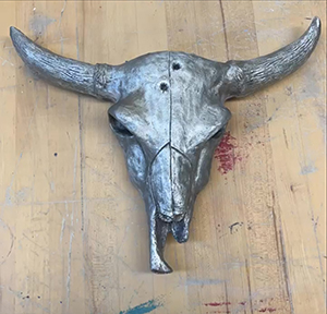 Image of the cast aluminum sculpture, Bull Skull by Anna Comly